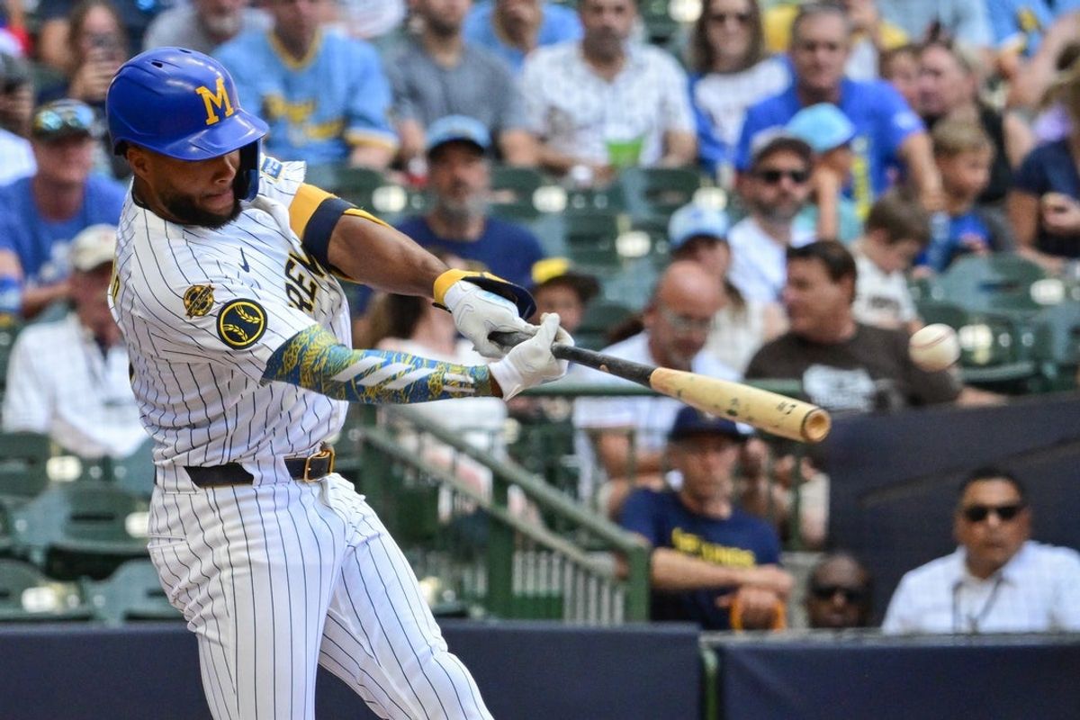 Jul 27, 2025; Milwaukee, Wisconsin, USA; Milwaukee Brewers center fielder Jackson Chourio (11) hits a double to drive in a run in the third inning against the Miami Marlins at American Family Field. Mandatory Credit: Benny Sieu-Imagn Images