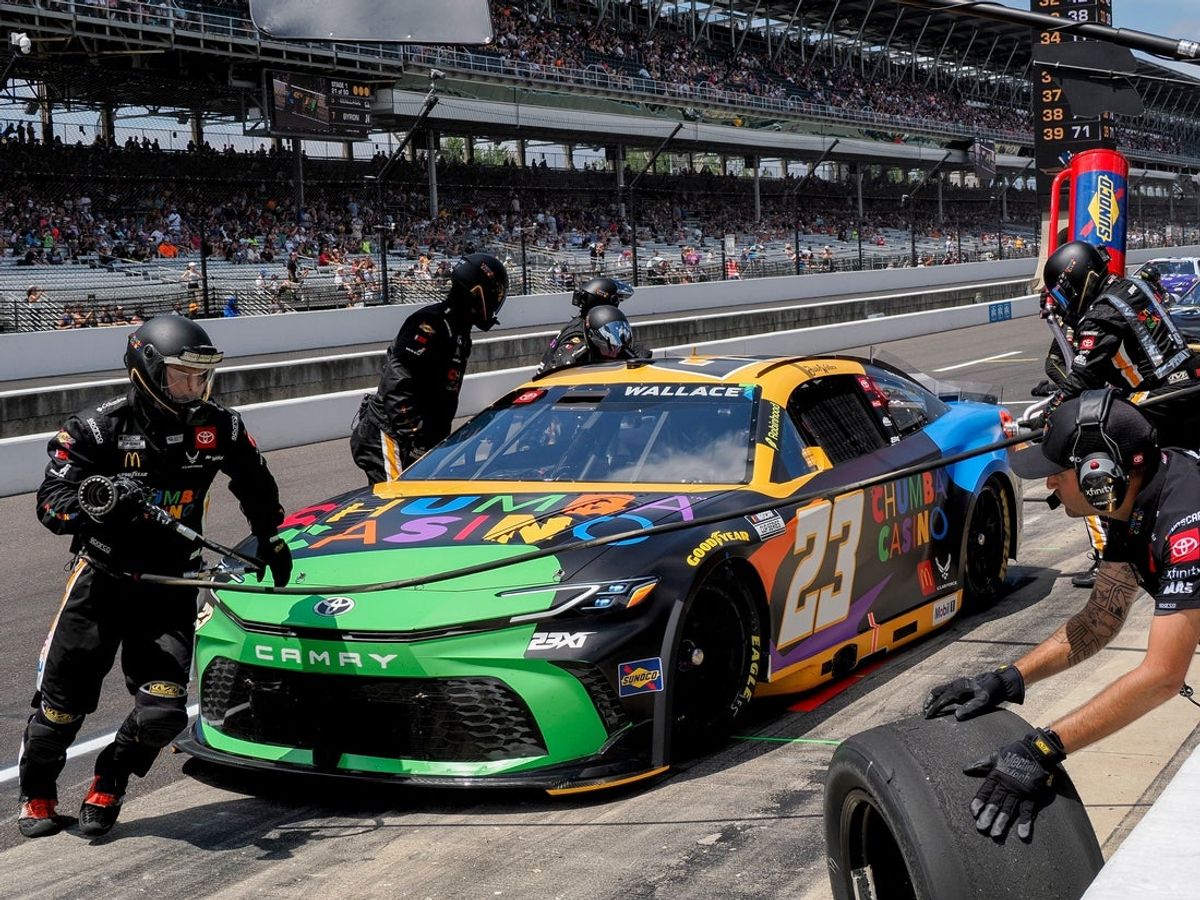 NASCAR Cup Series driver Bubba Wallace (23) makes a pit stop Sunday, July 27, 2025, during the Brickyard 400 at Indianapolis Motor Speedway.