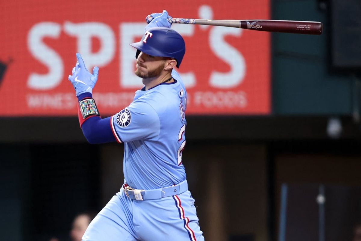 Jul 27, 2025; Arlington, Texas, USA; Texas Rangers catcher Jonah Heim (28) singles in a run during the third inning against the Atlanta Braves at Globe Life Field. Mandatory Credit: Tim Heitman-Imagn Images
