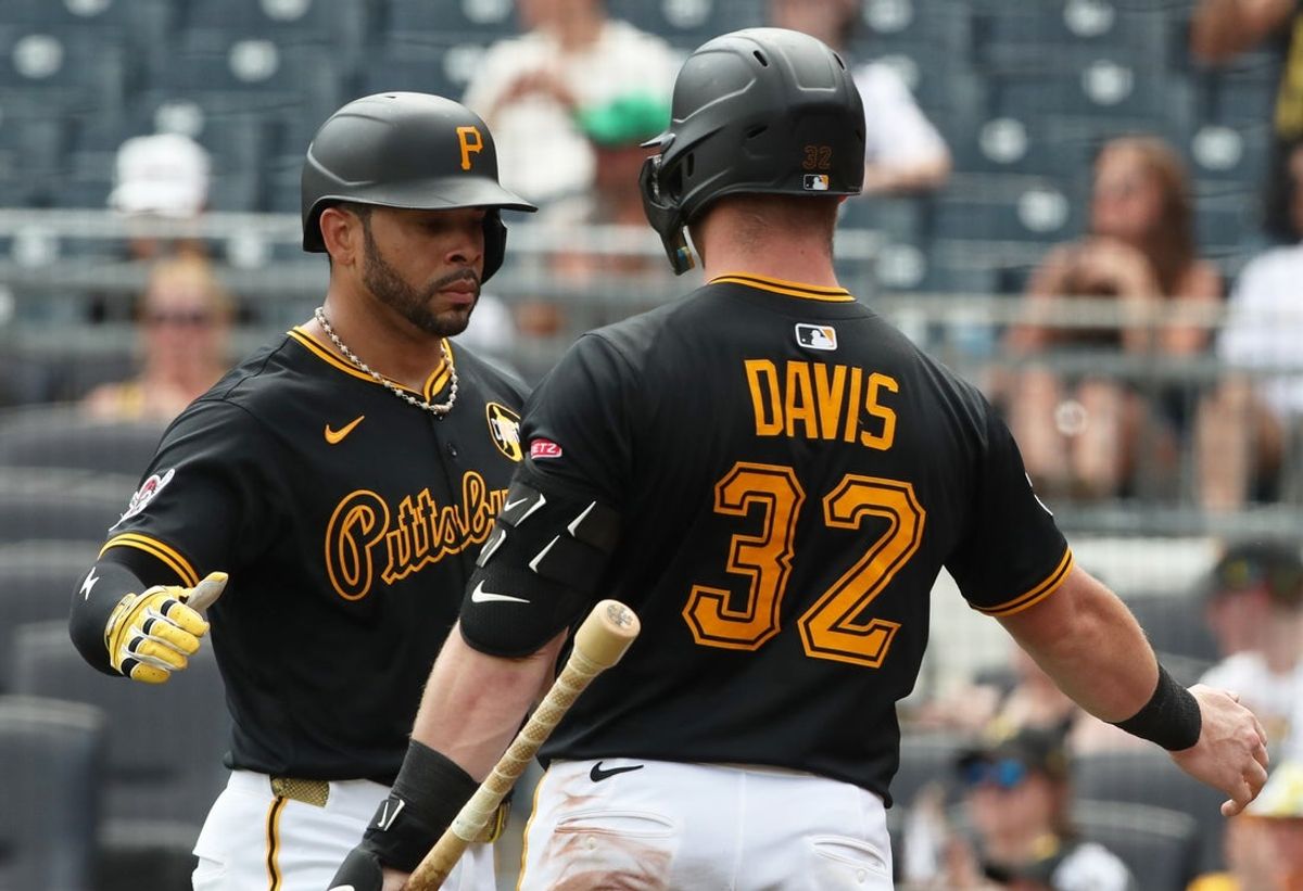 Jul 27, 2025; Pittsburgh, Pennsylvania, USA;  Pittsburgh Pirates left fielder Tommy Pham (left) celebrates with catcher Henry Davis (32) after Pham scored a run against the Arizona Diamondbacks during the eighth inning at PNC Park. Mandatory Credit: Charles LeClaire-Imagn Images