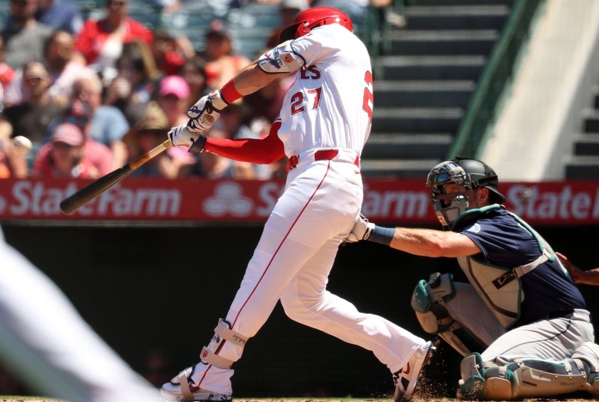 Jul 27, 2025; Anaheim, California, USA;  Los Angeles Angels designated hitter Mike Trout (27) hits a 2-run home run during the fifth inning against the Seattle Mariners at Angel Stadium. Mandatory Credit: Kiyoshi Mio-Imagn Images