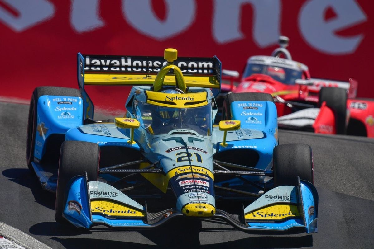 Jul 27, 2025; Salinas, California, USA; Ed Carpenter Racing driver Christian Rasmussen (21) leads Team Penske driver Will Power (12)  during the Monterey Grand Prix at WeatherTech Raceway Laguna Seca. Mandatory Credit: Gary A. Vasquez-Imagn Images