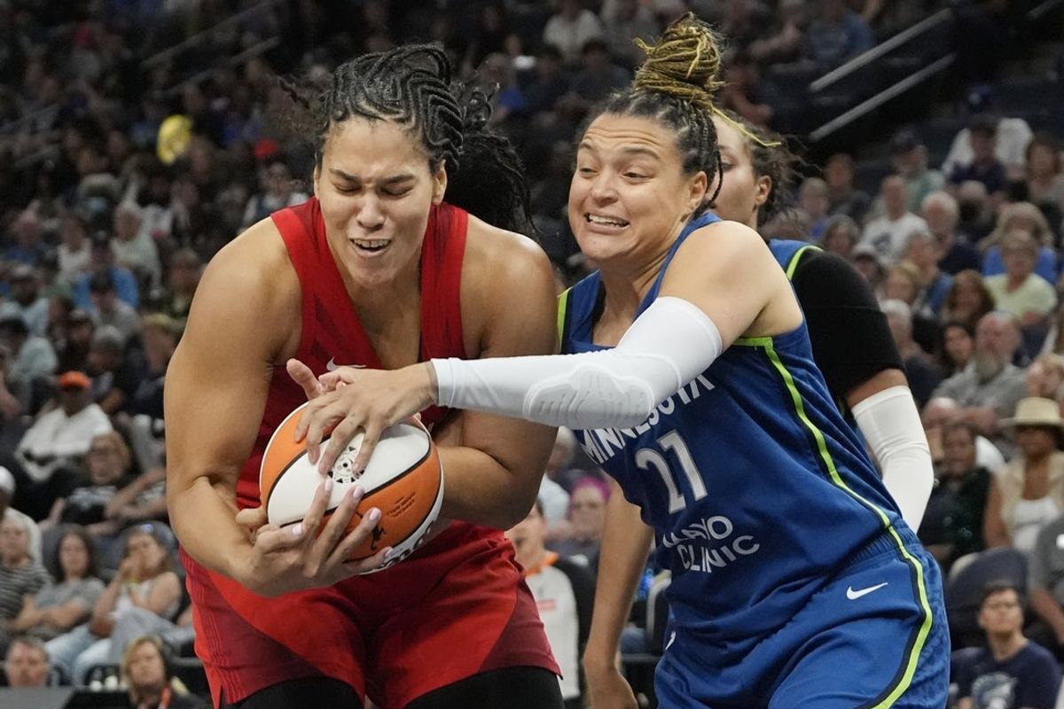 Jul 27, 2025; Minneapolis, Minnesota, USA; Atlanta Dream center Brittney Griner (42) and Minnesota Lynx guard Kayla McBride (21) vie for a rebound in the fourth quarter at Target Center. Mandatory Credit: Bruce Kluckhohn-Imagn Images