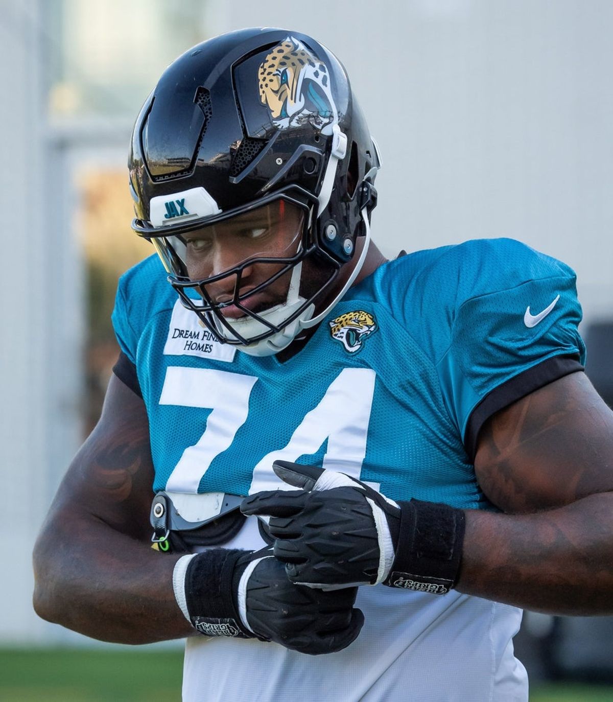 Jacksonville Jaguars offensive tackle Fred Johnson (74) buckles up his shoulder pads during the first day of pads during an NFL training camp fifth session at the Miller Electric Center, Monday, July 28, 2025, in Jacksonville, Fla. [Doug Engle/Florida Times-Union]