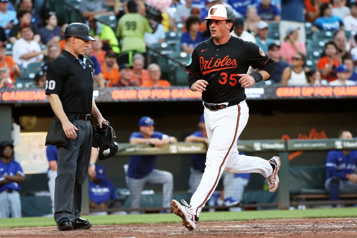 Jul 28, 2025; Baltimore, Maryland, USA; Baltimore Orioles catcher Adley Rutschman (35) scores during the third inning against the Toronto Blue Jays at Oriole Park at Camden Yards. Mandatory Credit: Daniel Kucin Jr.-Imagn Images