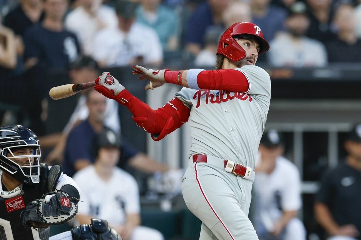 Jul 28, 2025; Chicago, Illinois, USA; Philadelphia Phillies second baseman Bryson Stott (5) singles against the Chicago White Sox during the third inning at Rate Field. Mandatory Credit: Kamil Krzaczynski-Imagn Images
