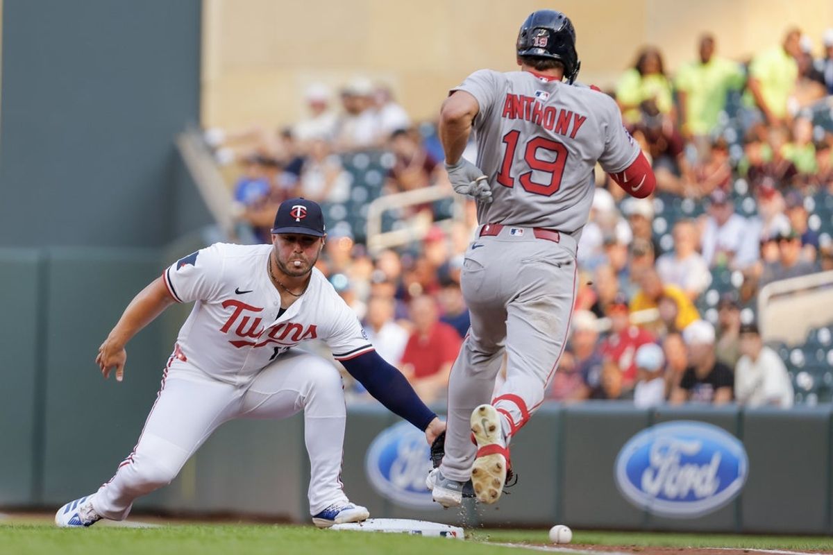 Jul 28, 2025; Minneapolis, Minnesota, USA; Minnesota Twins first baseman Ty France (13) cannot handle the errant throw by starting pitcher Simeon Woods Richardson (not pictured) that allows Boston Red Sox left fielder Roman Anthony (19) to advance to second base on his single in the first inning at Target Field. Mandatory Credit: Bruce Kluckhohn-Imagn Images