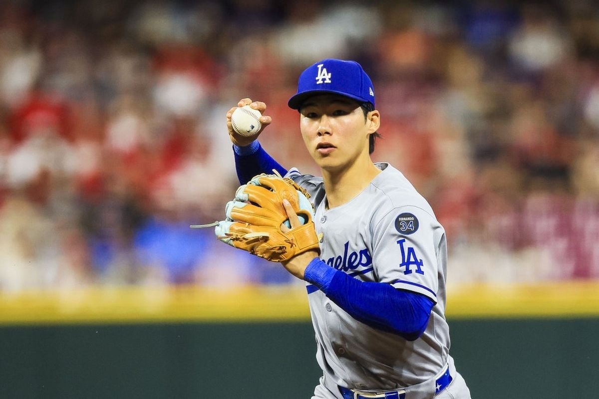 Jul 28, 2025; Cincinnati, Ohio, USA; Los Angeles Dodgers second baseman Hyeseong Kim (6) throws to first to get Cincinnati Reds outfielder TJ Friedl (not pictured) out in the eighth inning at Great American Ball Park. Mandatory Credit: Katie Stratman-Imagn Images