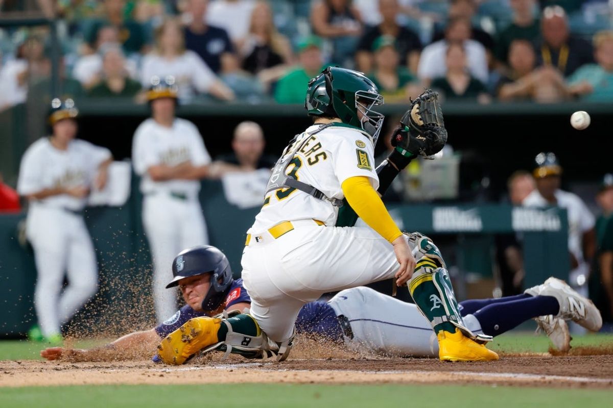 Jul 28, 2025; West Sacramento, California, USA; Seattle Mariners third baseman Ben Williamson (9) slides to score a run during the fifth inning against the Athletics at Sutter Health Park. Mandatory Credit: Sergio Estrada-Imagn Images
