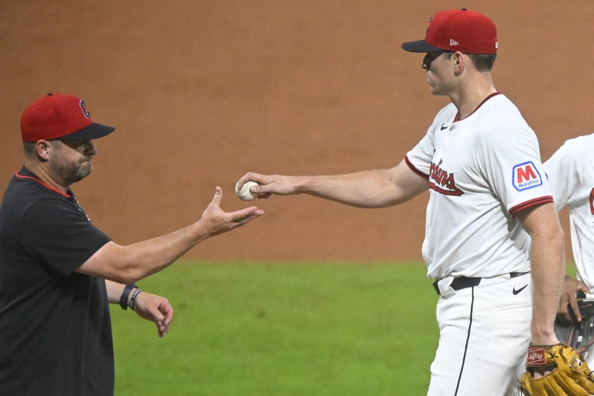 Jul 28, 2025; Cleveland, Ohio, USA; Cleveland Guardians manager Stephen Vogt (12) takes the ball from relief pitcher Cade Smith (36) during a pitching change in the ninth inning against the Colorado Rockies at Progressive Field. Mandatory Credit: David Richard-Imagn Images