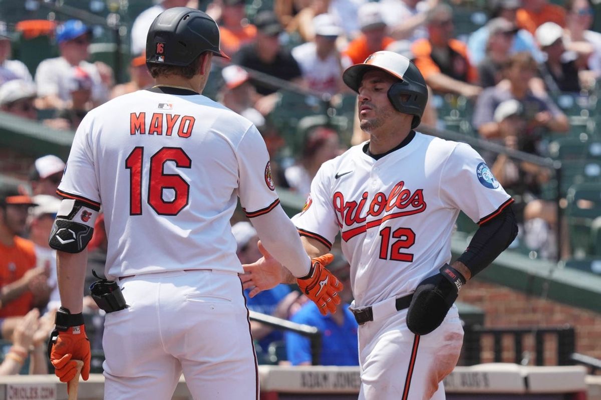 Jul 29, 2025; Baltimore, Maryland, USA; Baltimore Orioles designated hitter Ramon Laureano (12) is greeted by first baseman Coby Mayo (16) after scoring a run during the third inning against the Toronto Blue Jays at Oriole Park at Camden Yards. Mandatory Credit: Mitch Stringer-Imagn Images