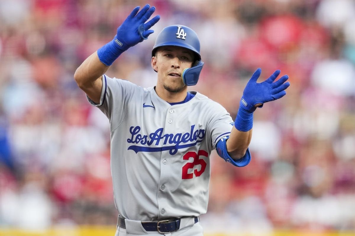 Jul 29, 2025; Cincinnati, Ohio, USA;  Los Angeles Dodgers second baseman Tommy Edman (25) gestures as he runs then bases after hitting a two-run home run against the Cincinnati Reds in the second inning at Great American Ball Park. Mandatory Credit: Aaron Doster-Imagn Images