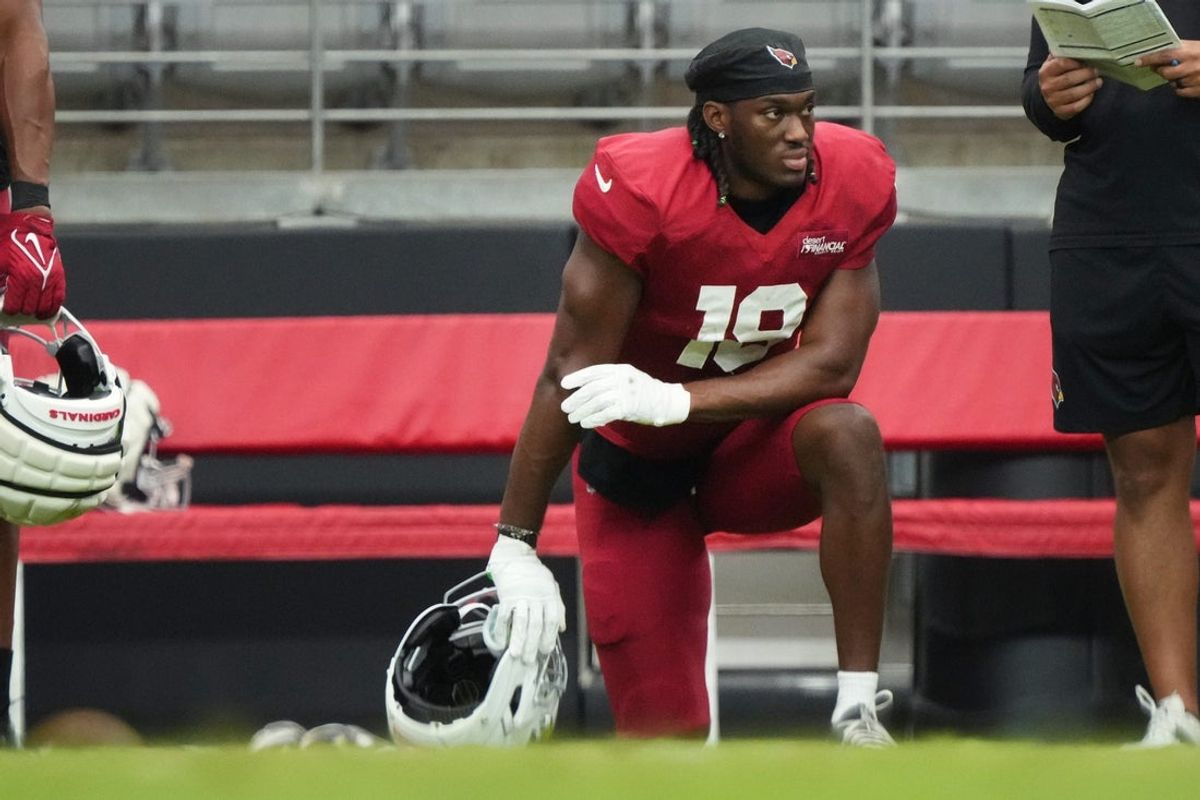 Arizona Cardinals receiver Marvin Harrison Jr. (18) watches from the sidelines during the team's practice at State Farm Stadium on July 29, 2025.