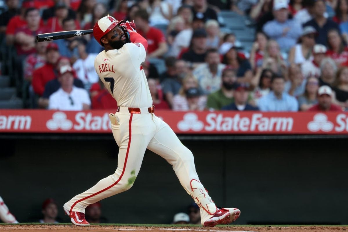 Jul 29, 2025; Anaheim, California, USA;  Los Angeles Angels center fielder Jo Adell (7) hits an RBI single during the first inning against the Texas Rangers at Angel Stadium. Mandatory Credit: Kiyoshi Mio-Imagn Images