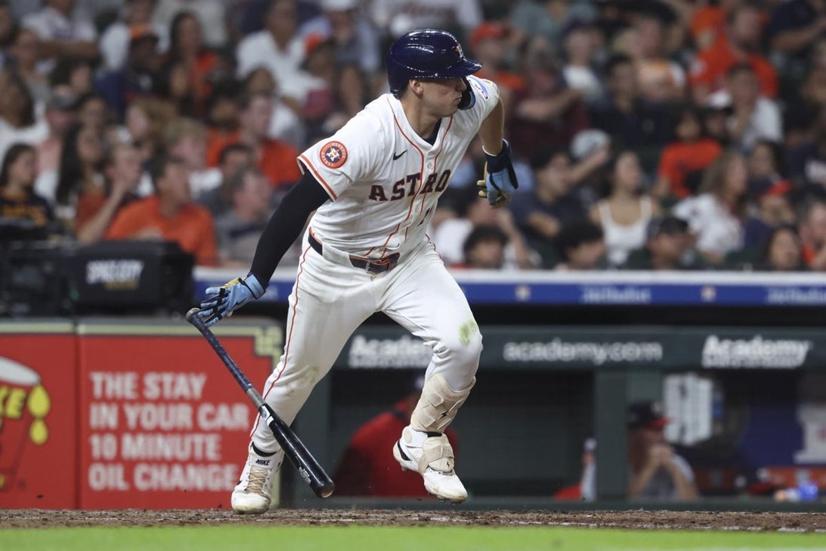 Jul 29, 2025; Houston, Texas, USA; Houston Astros second baseman Shay Whitcomb (10) hits an infield single during the sixth inning against the Washington Nationals at Daikin Park. Mandatory Credit: Troy Taormina-Imagn Images