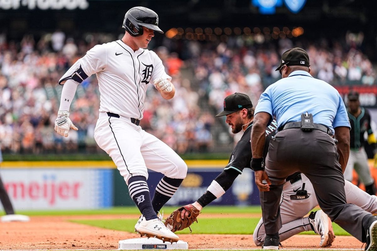 Detroit Tigers left fielder Kerry Carpenter (30) takes third base against Arizona Diamondbacks third base Blaze Alexander (9) during the third inning after batting a triple at Comerica Park in Detroit on Wednesday, July 30, 2025.