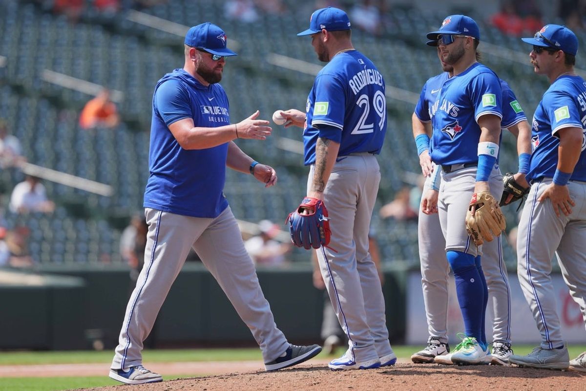 Jul 30, 2025; Baltimore, Maryland, USA; Toronto Blue Jays manager John Schneider (14) removes pitcher Yariel Rodriguez (29) during the seventh inning against the Baltimore Orioles during the first inning at Oriole Park at Camden Yards. Mandatory Credit: Mitch Stringer-Imagn Images