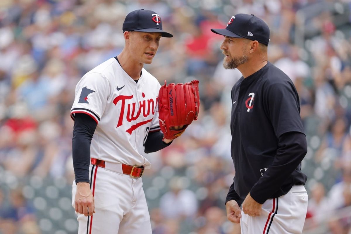 Jul 30, 2025; Minneapolis, Minnesota, USA; Minnesota Twins relief pitcher Griffin Jax (22) talks with manager Rocco Baldelli in the ninth inning of the game with the Boston Red Sox at Target Field. Baldelli then pulled Jax. Mandatory Credit: Bruce Kluckhohn-Imagn Images