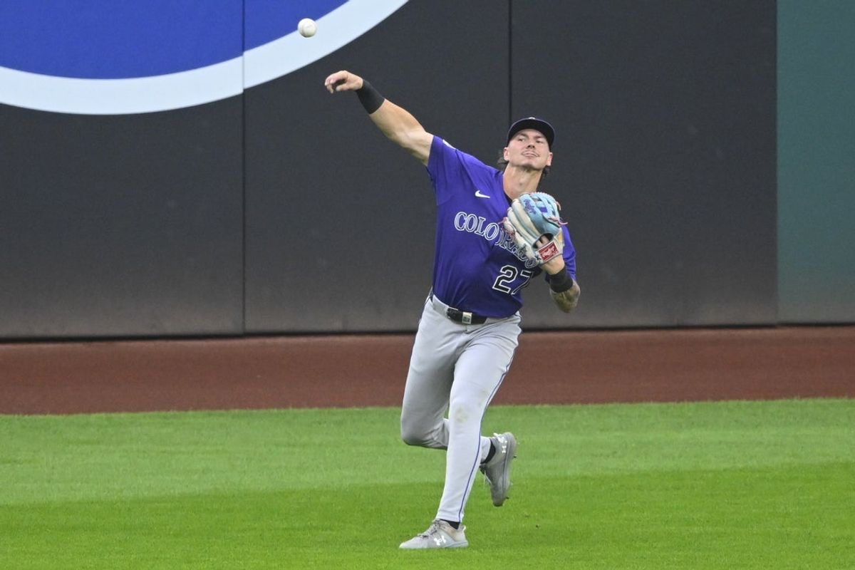Jul 30, 2025; Cleveland, Ohio, USA; Colorado Rockies left fielder Jordan Beck (27) throws the ball to the infield in the fourth inning against the Cleveland Guardians at Progressive Field. Mandatory Credit: David Richard-Imagn Images