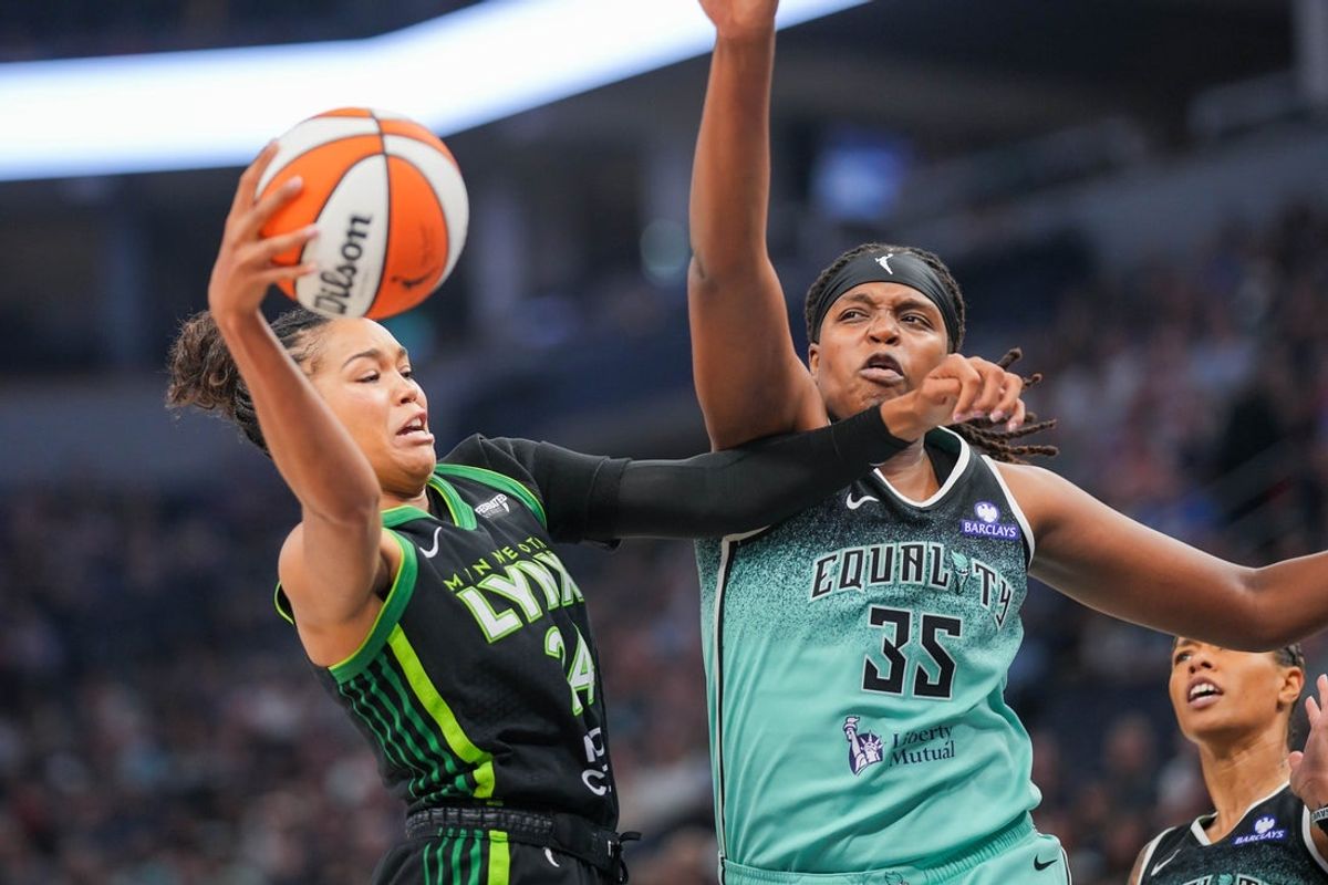 Jul 30, 2025; Minneapolis, Minnesota, USA; Minnesota Lynx forward Napheesa Collier (24) passes against New York Liberty center Jonquel Jones (35) in the first quarter at Target Center. Mandatory Credit: Brad Rempel-Imagn Images