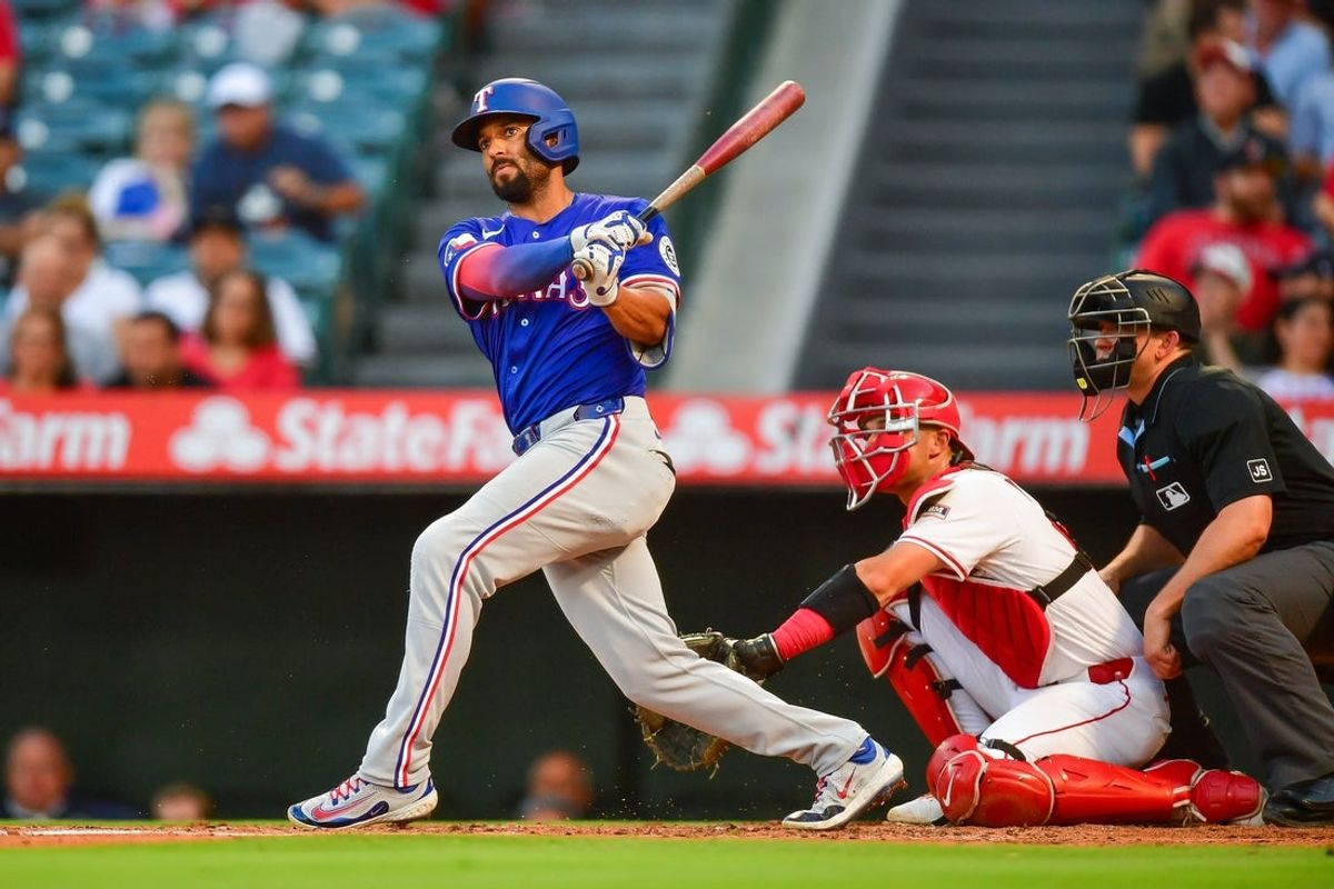 Jul 30, 2025; Anaheim, California, USA; Texas Rangers second baseman Marcus Semien (2) hits a double against the Los Angeles Angels during the fourth inning at Angel Stadium. Mandatory Credit: Gary A. Vasquez-Imagn Images