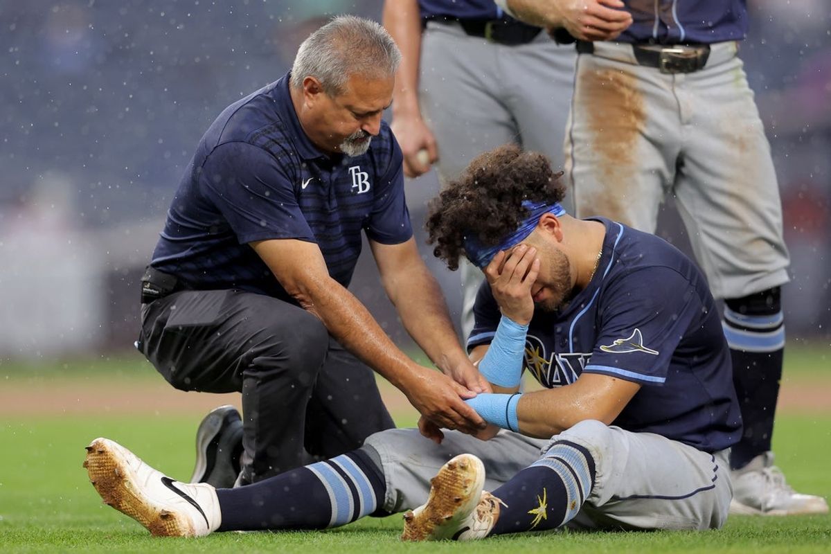 Jul 31, 2025; Bronx, New York, USA; Tampa Bay Rays first baseman Jonathan Aranda (62) is tended to after an injury after a collision with New York Yankees designated hitter Giancarlo Stanton (not pictured) during the fifth inning at Yankee Stadium. Mandatory Credit: Brad Penner-Imagn Images