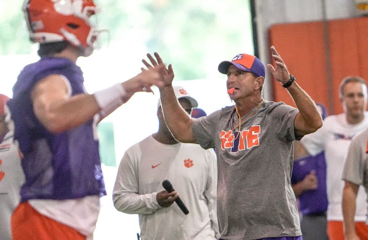 Clemson quarterback Cade Klubnik (2) and head coach Dabo Swinney at the start of fall workouts July 31.