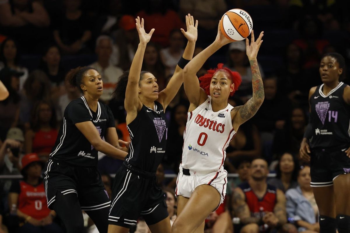 Jul 31, 2025; Washington, District of Columbia, USA; Washington Mystics forward Shakira Austin (0) passes the ball as Golden State Valkyries center Iliana Rupert (12) defends in the first half at CareFirst Arena. Mandatory Credit: Geoff Burke-Imagn Images