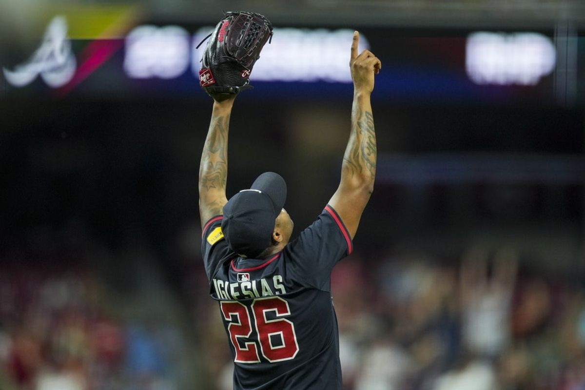 Jul 31, 2025; Cincinnati, OH, USA; Atlanta Braves pitcher Raisel Iglesias (26) reacts after the final out the game against the Cincinnati Reds at Great American Ball Park. Mandatory Credit: Aaron Doster-Imagn Images