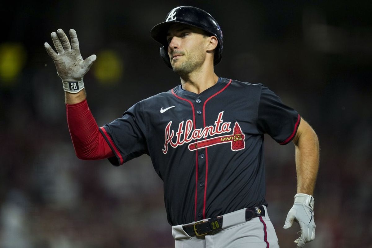 Jul 31, 2025; Cincinnati, OH, USA; Atlanta Braves first baseman Matt Olson (28) scores a run against the Cincinnati Reds on a sacrifice fly by Atlanta Braves designated hitter Marcell Ozuna in the 10th inning at Great American Ball Park. Mandatory Credit: Aaron Doster-Imagn Images