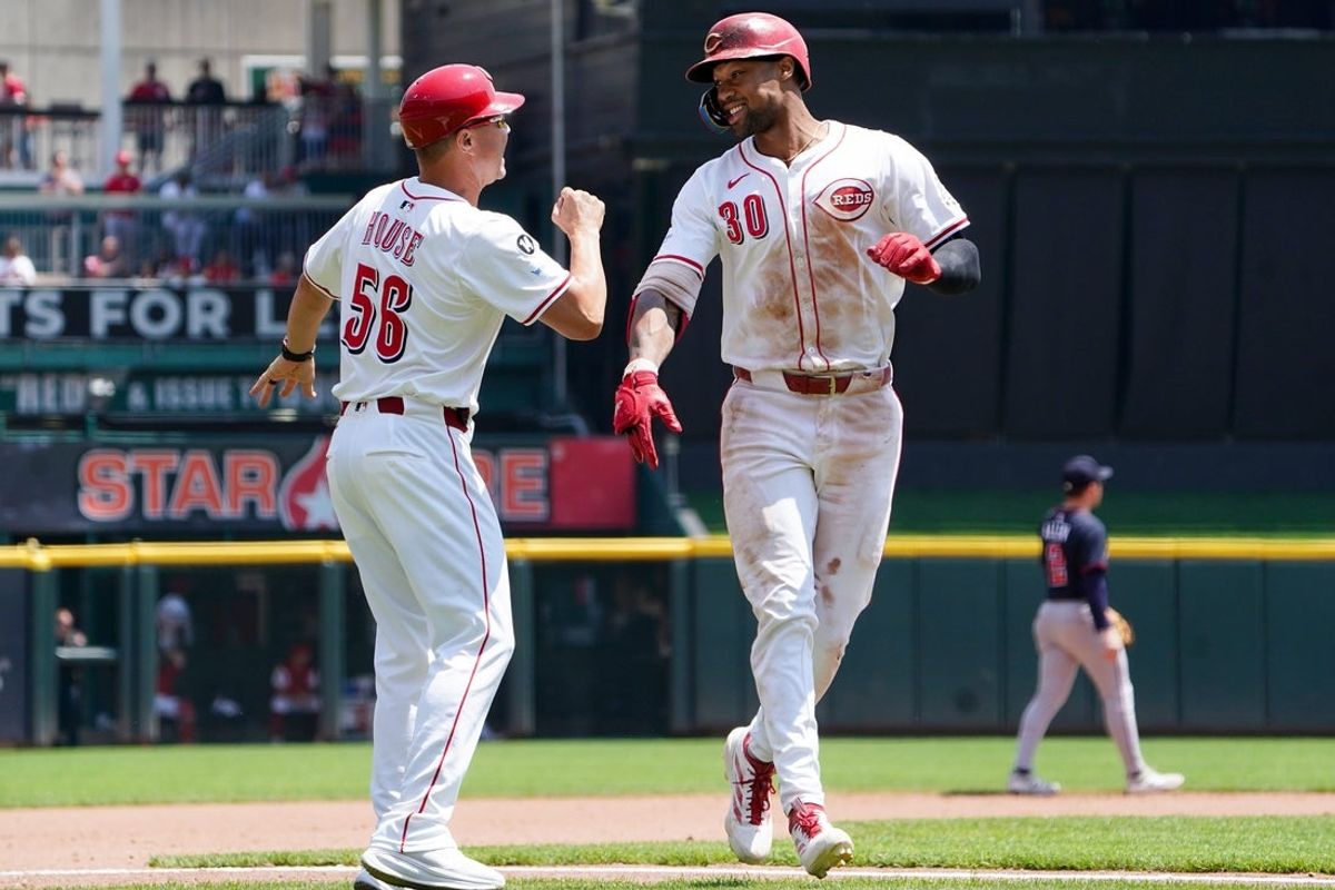 Cincinnati Reds centerfielder Will Benson (30) smiles as he passes Cincinnati Reds third base coach J.R. House (56) after hitting homer in the seventh inning of a MLB game between the Cincinnati Reds and Atlanta Braves, Friday, Aug. 1, 2025, at Great American Ball Park in Downtown Cincinnati. Reds won 3-2.