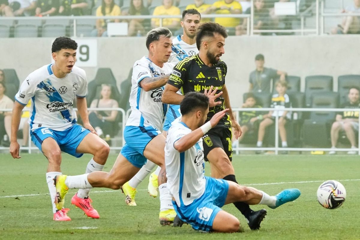 Columbus Crew forward Diego Rossi (10) scores past Club Puebla defender Nicolas Diaz (6) during the first half of the Leagues Cup soccer match at Lower.com Field in Columbus on Aug. 1, 2025.