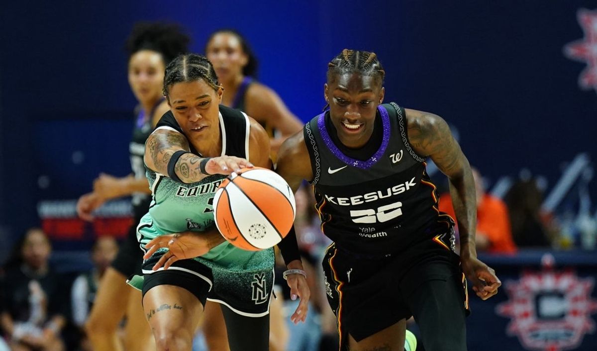 Aug 1, 2025; Uncasville, Connecticut, USA; Connecticut Sun guard Saniya Rivers (22) and New York Liberty guard Natasha Cloud (9) work for the ball in the first half at Mohegan Sun Arena. Mandatory Credit: David Butler II-Imagn Images