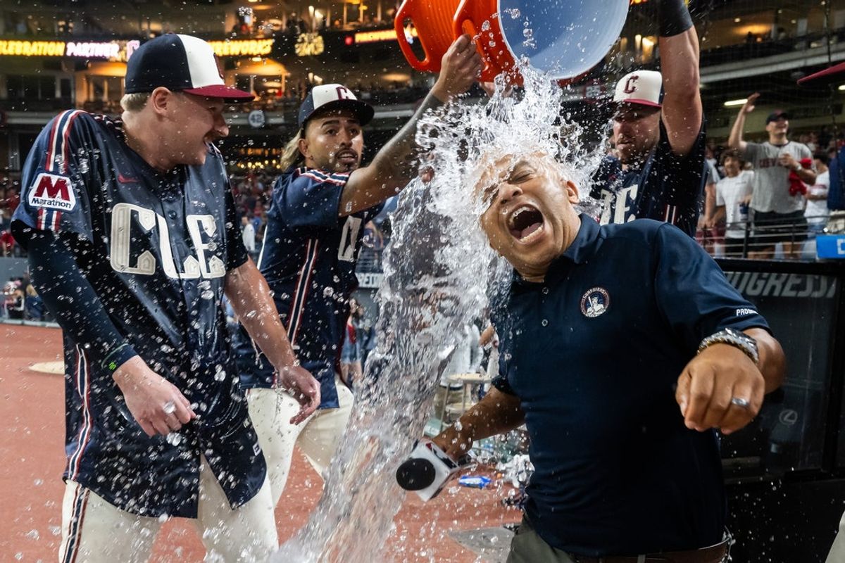 Aug 1, 2025; Cleveland, Ohio, USA; Cleveland Guardians designated hitter Kyle Manzardo, left, and television reporter Andre Knott, right, are doused with water by shortstop Gabriel Arias, second left, and outfielder Nolan Jones after Manzardo hit a walk-off RBI single during the tenth inning against the Minnesota Twins at Progressive Field. Mandatory Credit: Ken Blaze-Imagn Images