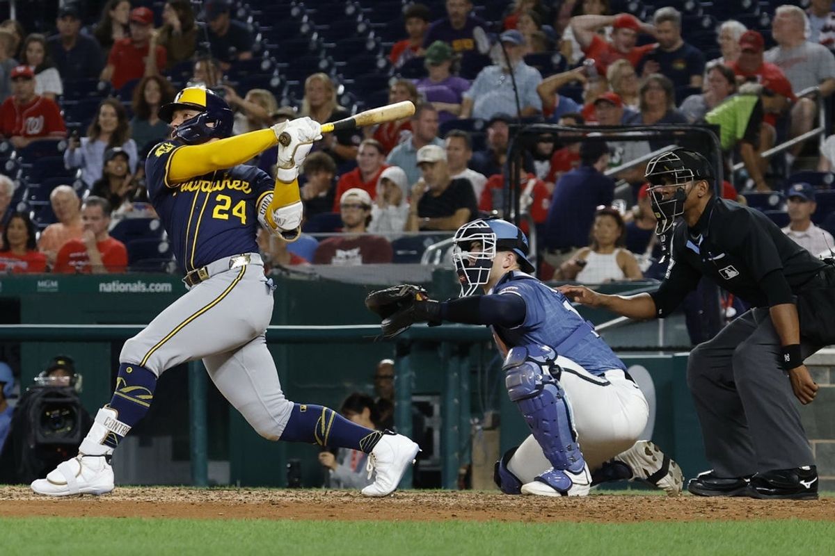 Aug 1, 2025; Washington, District of Columbia, USA; Milwaukee Brewers catcher William Contreras (24) doubles against the Washington Nationals during the eighth inning at Nationals Park. Mandatory Credit: Geoff Burke-Imagn Images