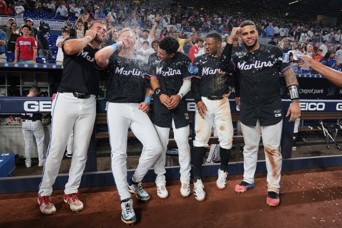 Aug 1, 2025; Miami, Florida, USA;  Miami Marlins center fielder Jakob Marsee (87), left fielder Kyle Stowers (28), third baseman Javier Sanoja (46), second baseman Xavier Edwards (9) and catcher Agustin Ramirez (50) celebrate after winning the game against the New York Yankees at loanDepot Park. Mandatory Credit: Sam Navarro-Imagn Images
