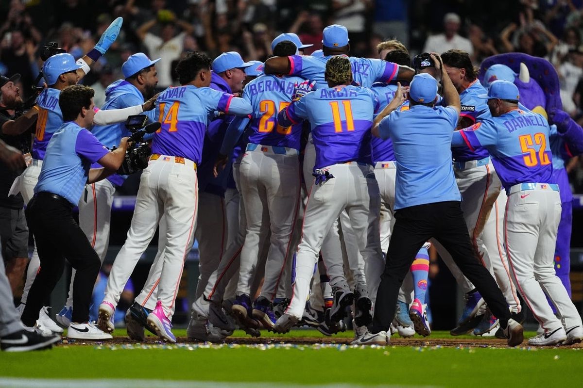 Aug 1, 2025; Denver, Colorado, USA; Members of the Colorado Rockies celebrate center fielder Brenton Doyle (9) (center) two run walk off home run in the ninth inning against the Pittsburgh Pirates at Coors Field. Mandatory Credit: Ron Chenoy-Imagn Images