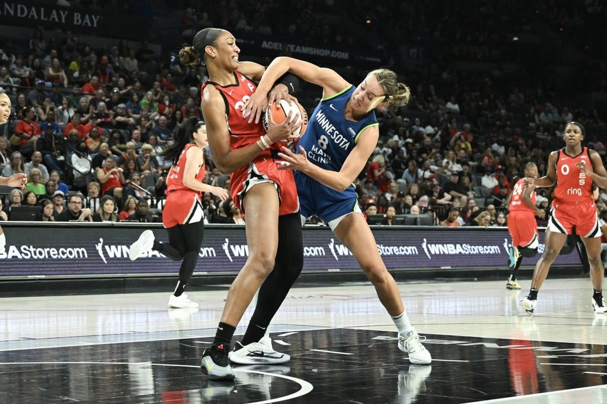 Aug 2, 2025; Las Vegas, Nevada, USA;  Las Vegas Aces center A'ja Wilson (22) and Minnesota Lynx forward Alanna Smith (8) battle for a rebound during the second quarter of their game at Michelob Ultra Arena. Mandatory Credit: Candice Ward-Imagn Images