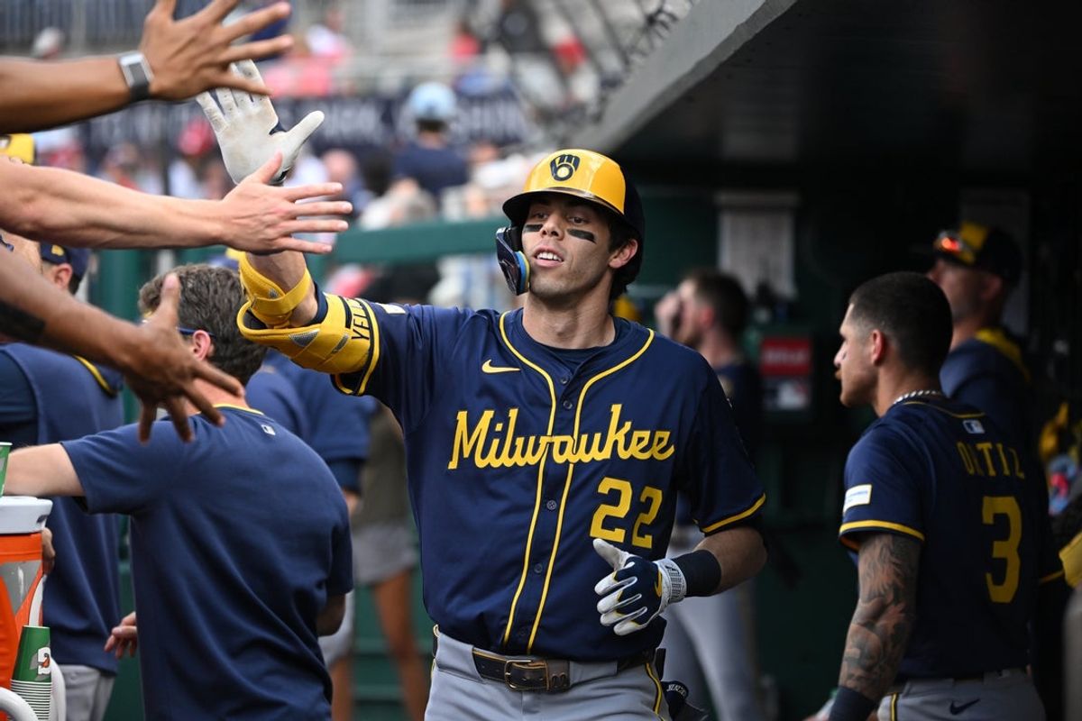 Aug 2, 2025; Washington, District of Columbia, USA; Milwaukee Brewers left fielder Christian Yelich (22) celebrates in the dugout after hitting a home run against the Washington Nationals during the third inning at Nationals Park. Mandatory Credit: Rafael Suanes-Imagn Images