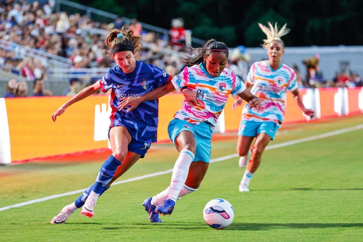 Aug 2, 2025; Cary, North Carolina, USA; San Diego Wave FC defender Perle Morroni (75) dribbles the ball past North Carolina Courage defender Ryan Williams (13) during the first half of the game at First Horizon Stadium at WakeMed Soccer Park. Mandatory Credit: Jaylynn Nash-Imagn Images