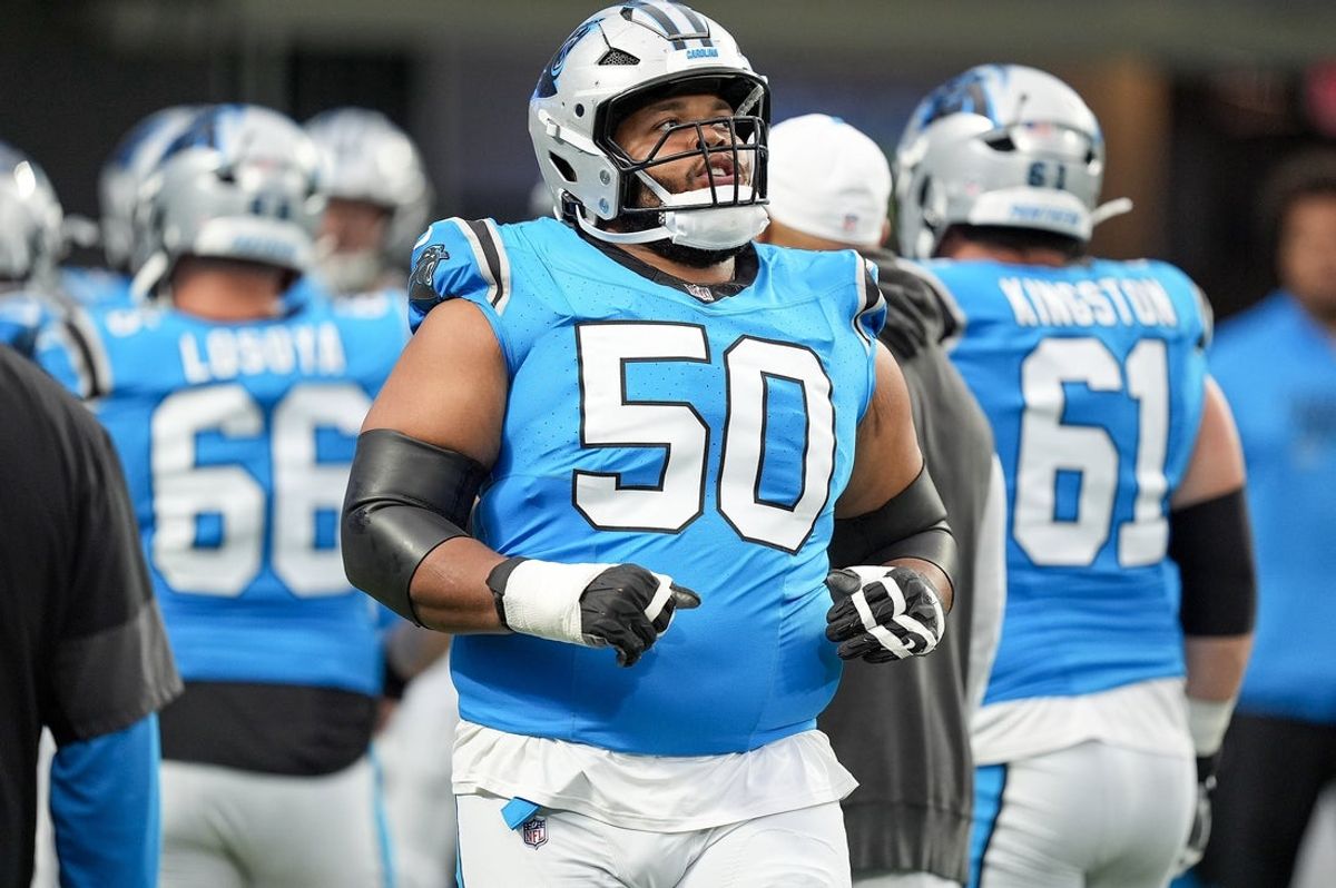 Aug 2, 2025; Charlottle, NC, USA; Carolina Panthers guard Robert Hunt (50) takes the field during Fanfest at Bank of America Stadium. Mandatory Credit: Jim Dedmon-Imagn Images
