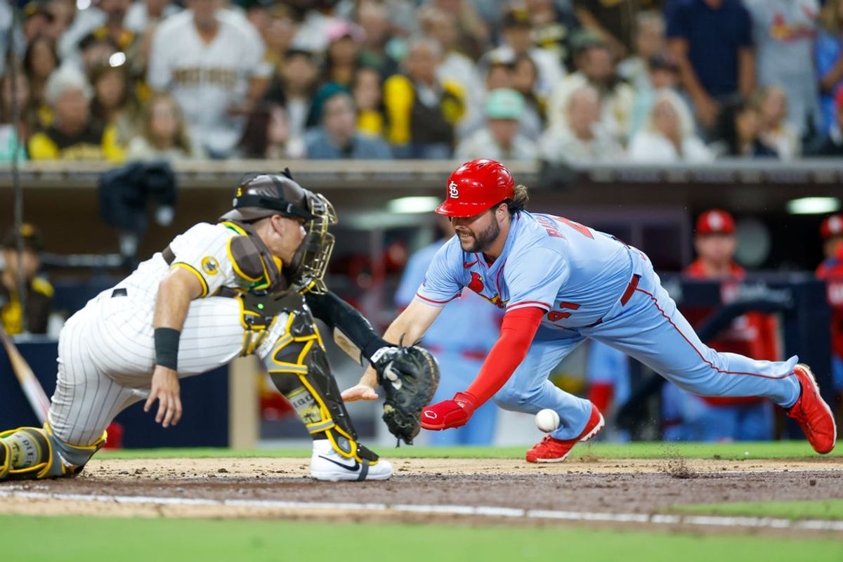Aug 2, 2025; San Diego, California, USA; St. Louis Cardinals left fielder Alec Burleson (41) slides into home plate to score a run during the fifth inning against the San Diego Padres at Petco Park. Mandatory Credit: David Frerker-Imagn Images