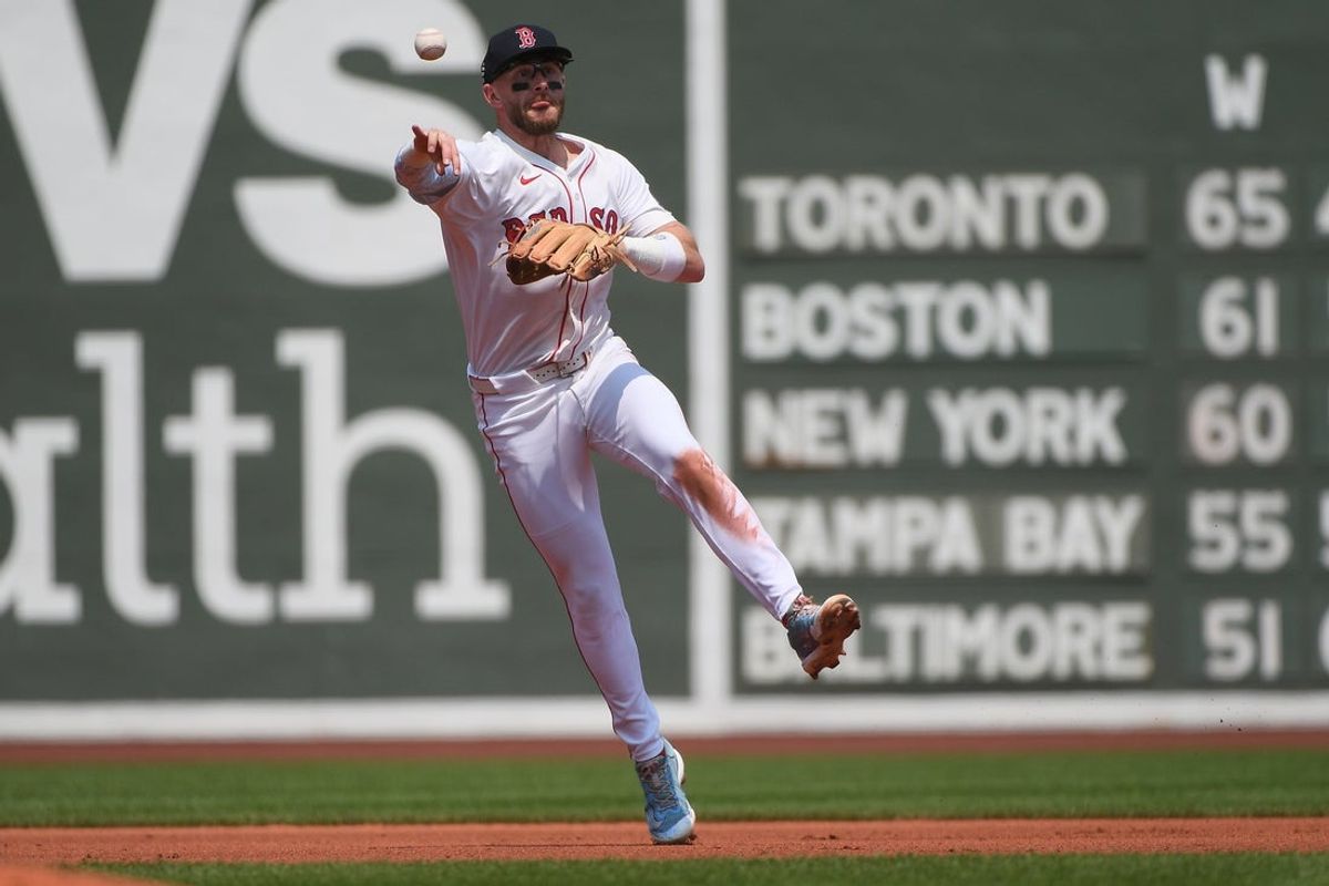 Aug 3, 2025; Boston, Massachusetts, USA; Boston Red Sox shortstop Trevor Story (10) throws to first for an out during the fourth inning against the Houston Astros at Fenway Park. Mandatory Credit: Bob DeChiara-Imagn Images
