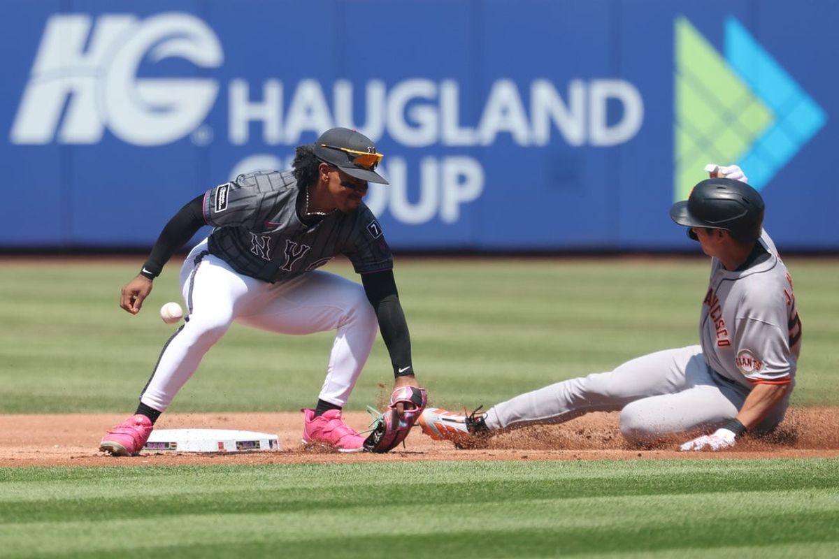 Aug 3, 2025; New York City, New York, USA; San Francisco Giants center fielder Jung Hoo Lee (51) steals second base as New York Mets shortstop Francisco Lindor (12) can not secure the throw during the third inning at Citi Field. Mandatory Credit: Vincent Carchietta-Imagn Images