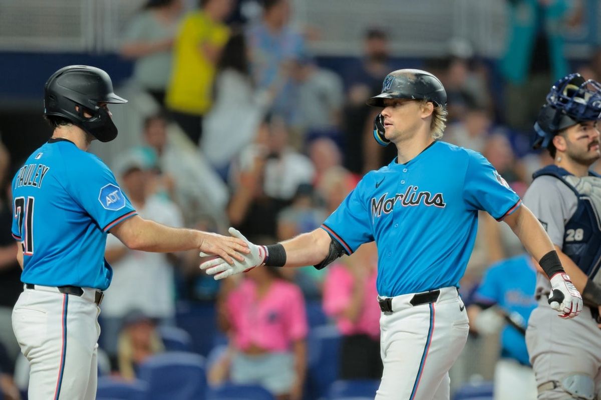 Aug 3, 2025; Miami, Florida, USA; Miami Marlins left fielder Kyle Stowers (28) celebrates with third baseman Graham Pauley (21) after hitting a three-run home run against the New York Yankees during the fourth inning at loanDepot Park. Mandatory Credit: Sam Navarro-Imagn Images