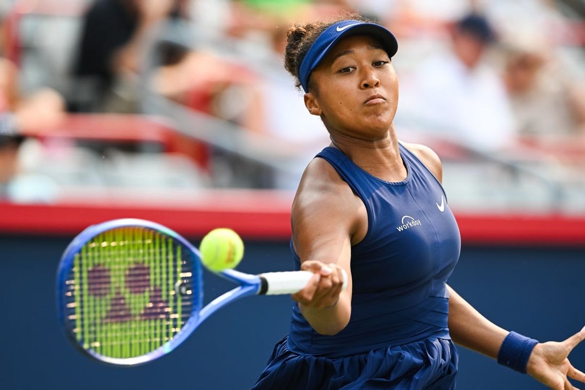 Aug 3, 2025; Montreal, QC, Canada; Naomi Osaka (JPN) returns the ball to Anastasija Sevastova (LAT) in fourth round play at IGA Stadium. Mandatory Credit: David Kirouac-Imagn Images
