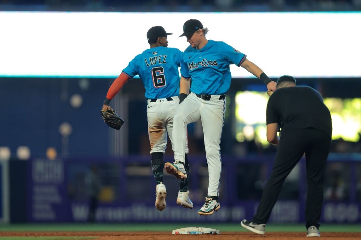 Aug 3, 2025; Miami, Florida, USA; Miami Marlins shortstop Otto Lopez (6) and Miami Marlins left fielder Kyle Stowers (28) celebrate after winning the game against the New York Yankees at loanDepot Park. Mandatory Credit: Sam Navarro-Imagn Images