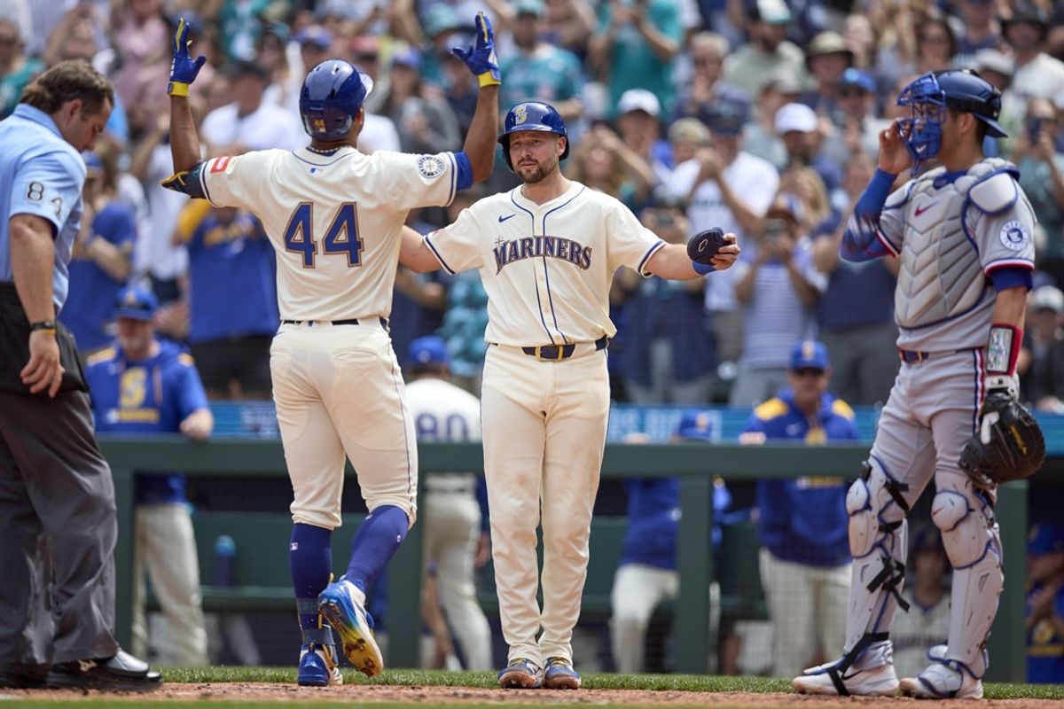 Aug 3, 2025; Seattle, Washington, USA; Seattle Mariners center fielder Julio Rodríguez (44) celebrates at home with Seattle Mariners catcher Cal Raleigh (29) his two RBI home run off Texas Rangers starting pitcher Jacob deGrom (48) during the third inning at T-Mobile Park. Mandatory Credit: John Froschauer-Imagn Images