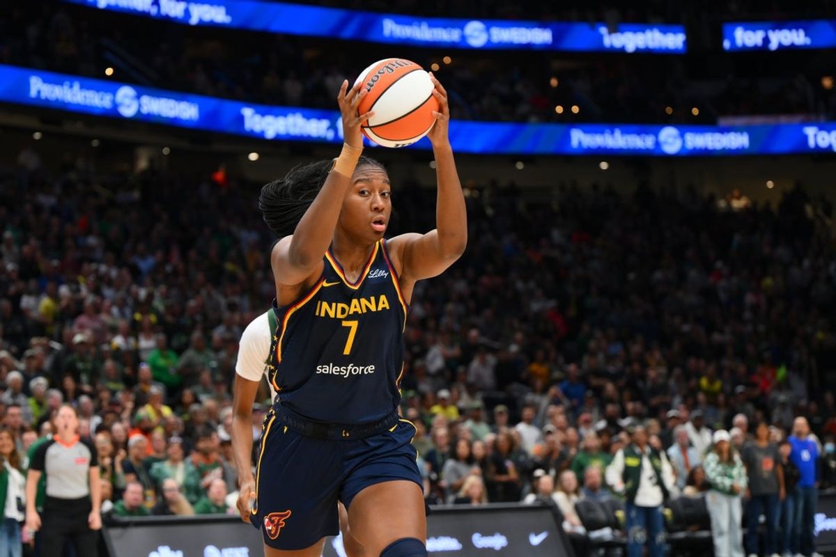 Aug 3, 2025; Seattle, Washington, USA; Indiana Fever forward Aliyah Boston (7) rebounds the ball against the Seattle Storm during the second half at Climate Pledge Arena. Mandatory Credit: Steven Bisig-Imagn Images
