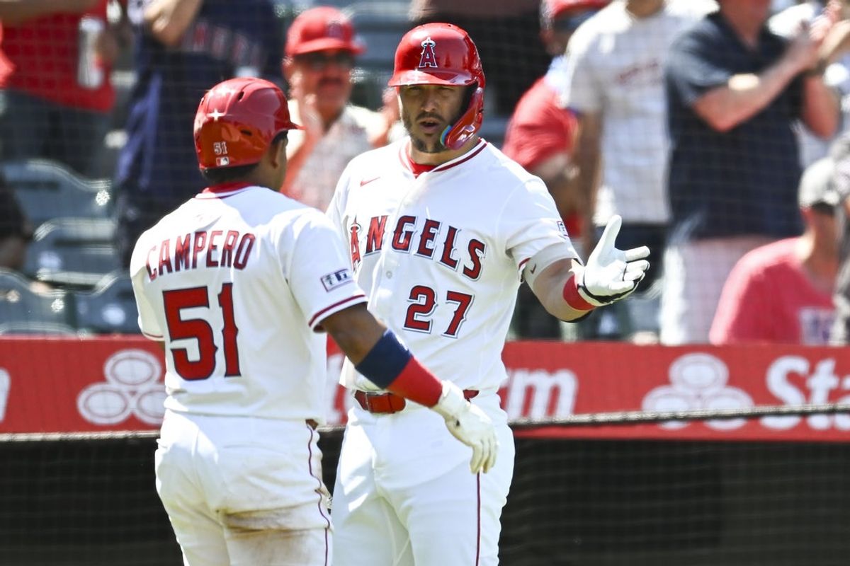 Aug 3, 2025; Anaheim, California, USA; Los Angeles Angels outfielder Gustavo Campero (51) celebrates with outfielder Mike Trout (27) after scoring a run against the Chicago White Sox during the seventh inning at Angel Stadium. Mandatory Credit: Jonathan Hui-Imagn Images